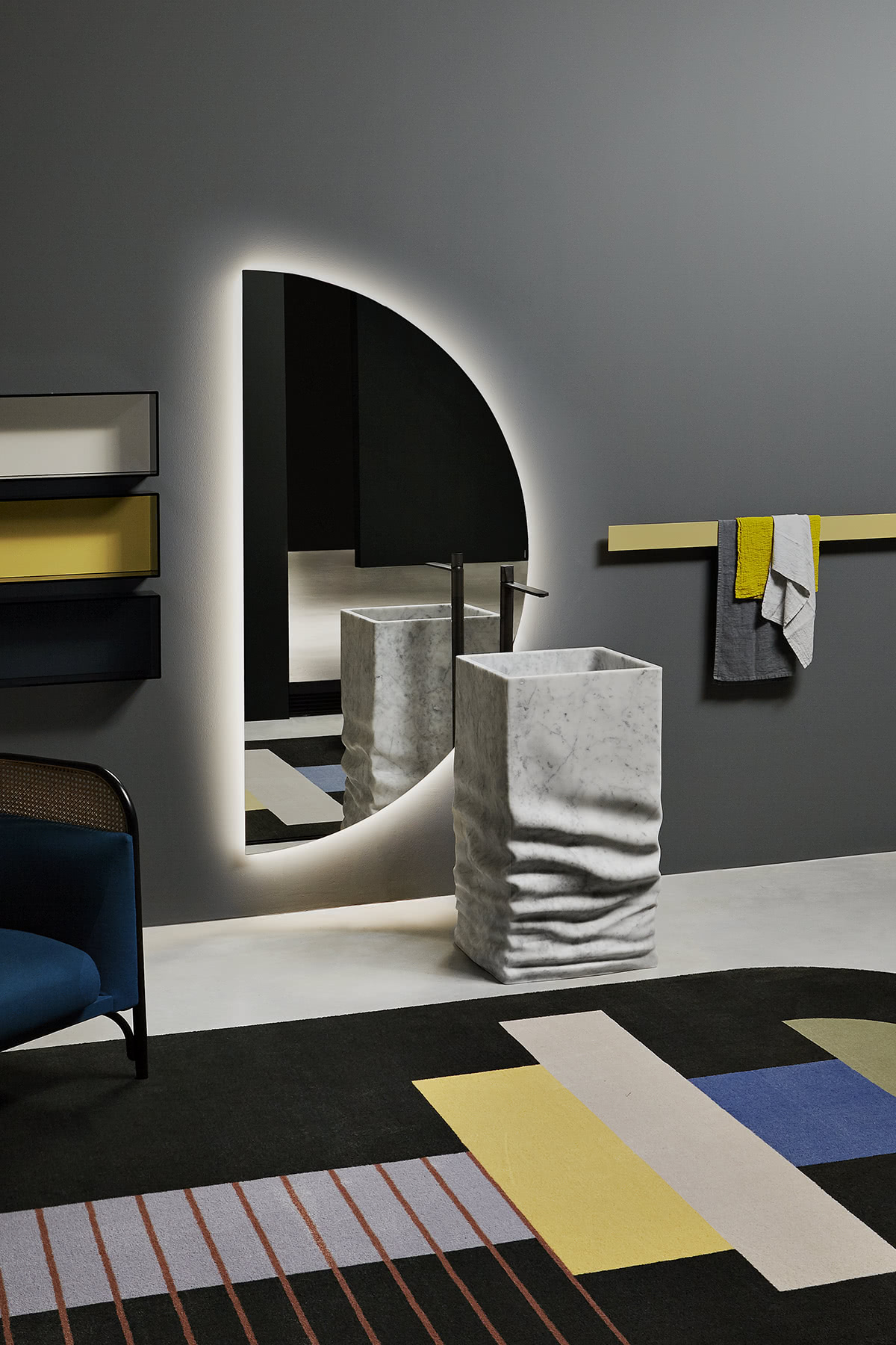 the idea of a marble sink with the effect of a “soft marble block”, compressed; an almost surreal object.