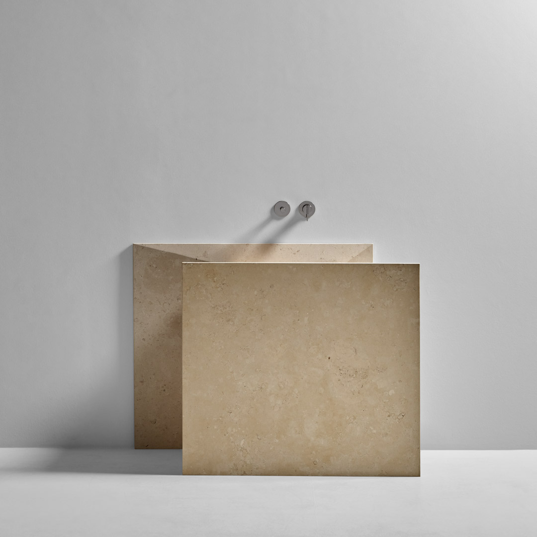 a marble origami that seems to have emerged from the wall 