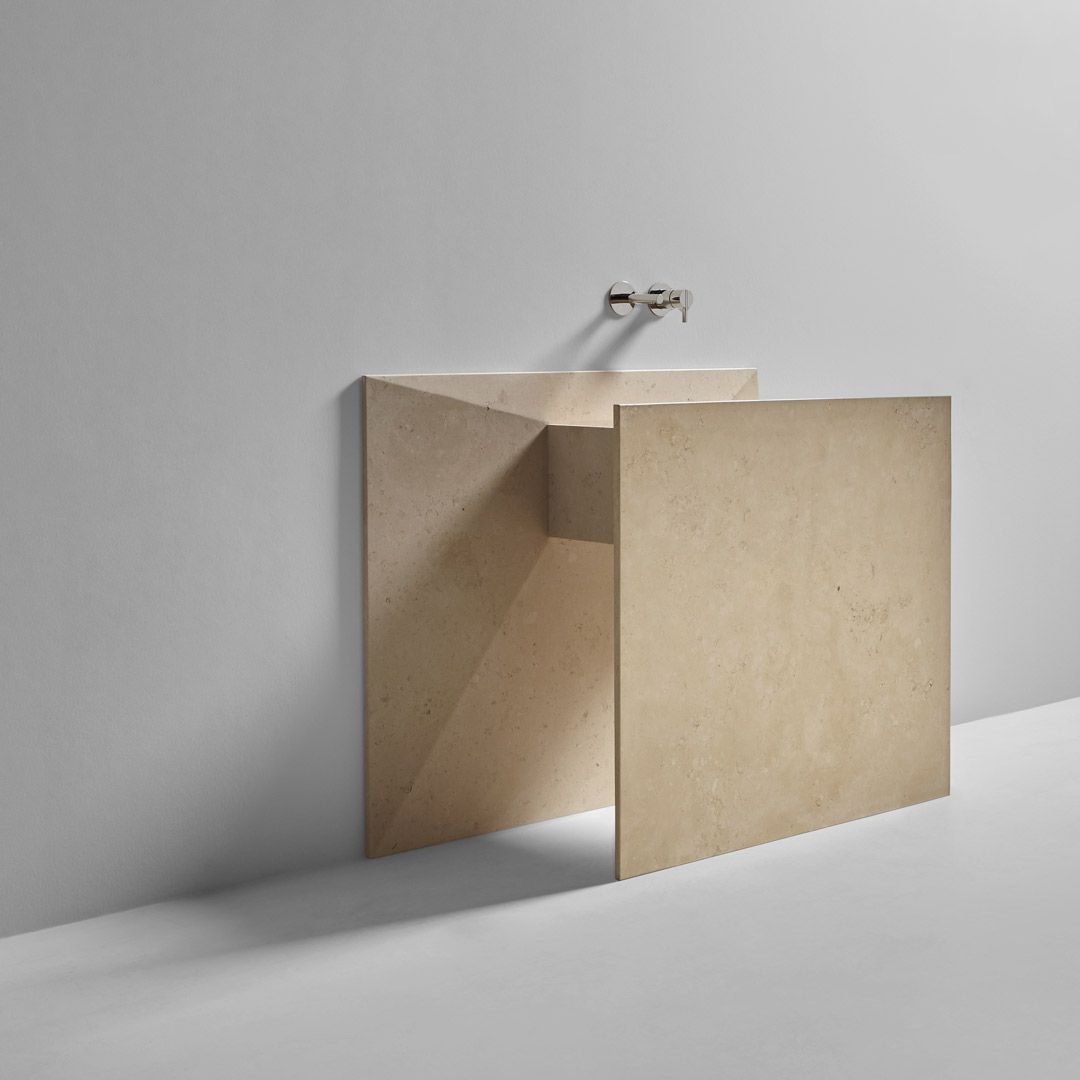 a marble origami that seems to have emerged from the wall 